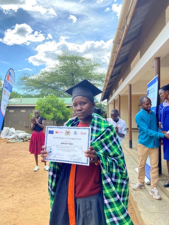 Maria displaying her Certificate during graduation as one of the best performers trained by C&D through the EU- IOYPE project at Naoi Home Based Care during graduation.